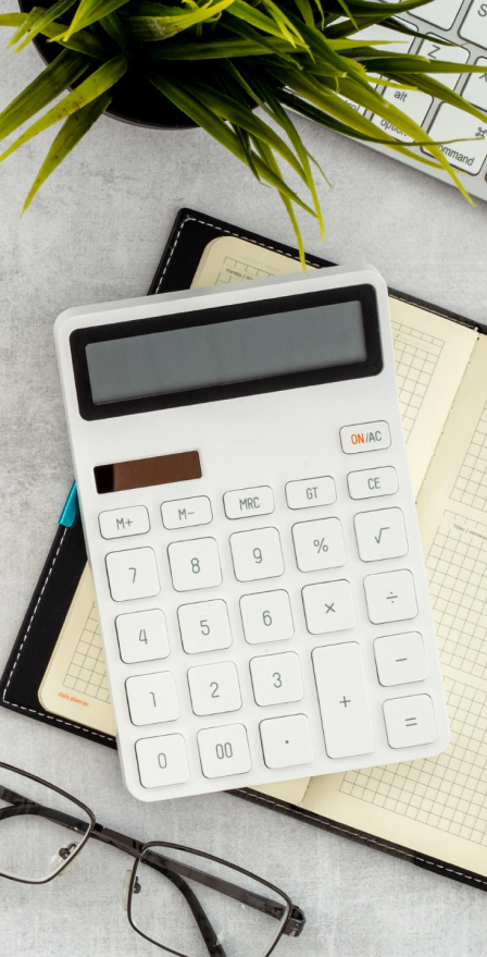 white calculator over book